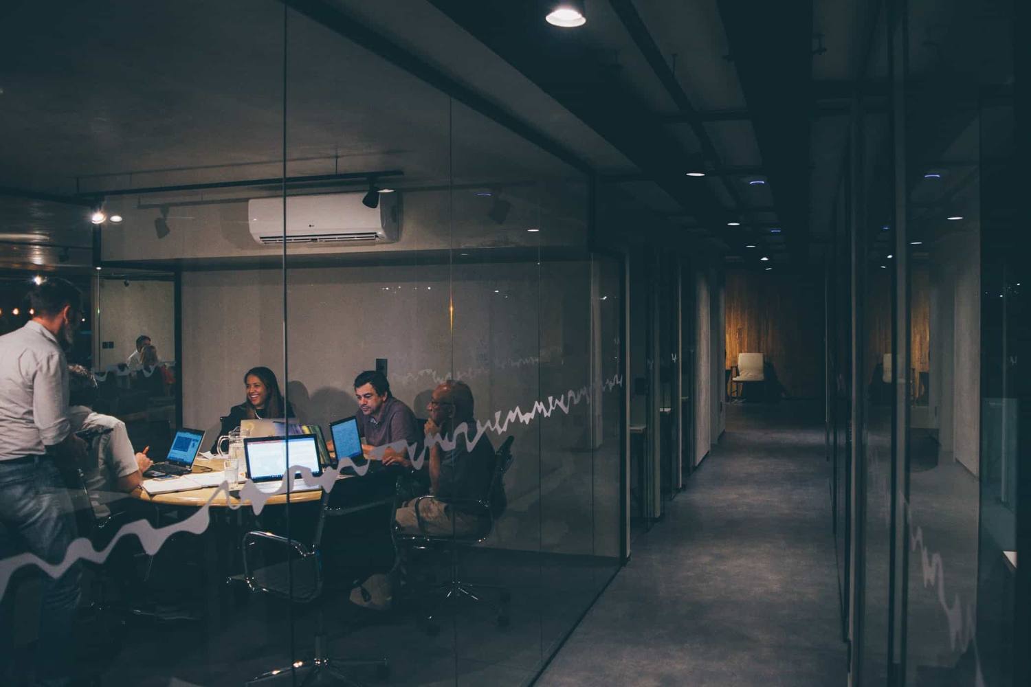 A business owner and her team planning together in a meeting room